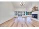 Bright living room with wood floors, a fireplace, and multiple windows offering ample natural light at 1953 Moyer Dr, Henderson, NV 89074