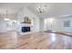 Spacious living room with wood floors, a fireplace, and seamless flow to the kitchen, perfect for entertaining at 1953 Moyer Dr, Henderson, NV 89074