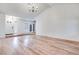 Spacious living room featuring wood floors, chandelier and lots of natural light at 1953 Moyer Dr, Henderson, NV 89074