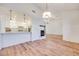 Open-concept living room and kitchen with breakfast bar and a modern fireplace at 1953 Moyer Dr, Henderson, NV 89074