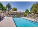 Community pool featuring lounge chairs, a jacuzzi, and well-manicured landscaping at 1953 Moyer Dr, Henderson, NV 89074