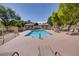 Community pool showcasing serene environment with poolside seating, shade and mature trees at 1953 Moyer Dr, Henderson, NV 89074