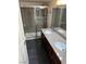 Bathroom featuring double sinks, granite countertops, and a glass door shower at 2212 Sunfish Dr # D, Henderson, NV 89014
