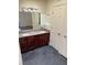 Bathroom featuring double sinks, granite countertops, and modern lighting at 2212 Sunfish Dr # D, Henderson, NV 89014