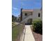 Inviting two-story condo featuring well-maintained landscaping, and a pathway to the front door at 2212 Sunfish Dr # D, Henderson, NV 89014