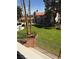 Multi-story condo building surrounded by well-manicured green lawn, trees, and plants at 2212 Sunfish Dr # D, Henderson, NV 89014