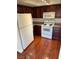Kitchen with white appliances, granite countertops, and wood cabinets at 2212 Sunfish Dr # D, Henderson, NV 89014