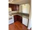 View of the kitchen featuring white appliances, granite countertops and wood cabinets at 2212 Sunfish Dr # D, Henderson, NV 89014