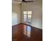 Bright living area with wood floors and doors leading to private outdoor balcony at 2212 Sunfish Dr # D, Henderson, NV 89014