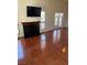 Bright living area with fireplace, TV, and wood floors with access to the outside via glass paneled double doors at 2212 Sunfish Dr # D, Henderson, NV 89014