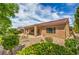 Backyard of home features a covered patio, low water landscaping, and mature greenery at 2365 Wisconsin Dells Dr, Henderson, NV 89044