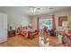 Bright bedroom featuring hardwood floors, a ceiling fan, a large window and a decorative bed at 2365 Wisconsin Dells Dr, Henderson, NV 89044