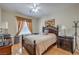 Cozy bedroom with a ceiling fan, wooden floors, and a decorative painting at 2365 Wisconsin Dells Dr, Henderson, NV 89044