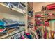 Organized walk-in closet with shelves and hanging space for clothes and luggage at 2365 Wisconsin Dells Dr, Henderson, NV 89044