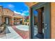 Inviting courtyard with brick accents, a seating area, and a view of lush greenery at 2365 Wisconsin Dells Dr, Henderson, NV 89044