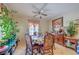 Cozy dining area with a decorative ceiling fan and view to the lush outdoors at 2365 Wisconsin Dells Dr, Henderson, NV 89044