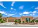 Single-story home with beautiful landscaping, a cozy front porch, and a two-car garage at 2365 Wisconsin Dells Dr, Henderson, NV 89044