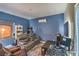 Contemporary living room with a vibrant blue wall, sleek furniture, and modern audio equipment at 2365 Wisconsin Dells Dr, Henderson, NV 89044