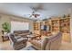 Comfortable living room featuring built-in bookcases, a ceiling fan, and lots of natural light at 2365 Wisconsin Dells Dr, Henderson, NV 89044