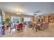 Open-concept living and dining area with tile floors, built-in shelving, and large windows at 2365 Wisconsin Dells Dr, Henderson, NV 89044