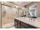 Modern bathroom with a double sink vanity, glass enclosed shower, and neutral color scheme at 2507 Silent View Ave, Henderson, NV 89044