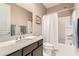 Bright bathroom featuring a shower-tub combination, white vanity, and neutral walls at 2507 Silent View Ave, Henderson, NV 89044