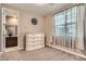 Neutral bedroom featuring a large window, carpeted floors, and ensuite bathroom access at 2507 Silent View Ave, Henderson, NV 89044
