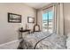Bedroom with window view, neutral colored walls, and framed pictures at 2507 Silent View Ave, Henderson, NV 89044