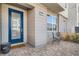 Inviting front entrance featuring a bright blue door and charming outdoor seating area at 2507 Silent View Ave, Henderson, NV 89044