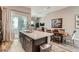 Open-concept kitchen with modern island, dining area, and balcony access at 2507 Silent View Ave, Henderson, NV 89044