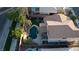 Stunning aerial view of a private backyard oasis with pool, lush landscaping, and patio with seating, and a well manicured backyard at 2549 Sundew Ave, Henderson, NV 89052