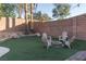 Cozy backyard seating area with artificial turf and a charming fire pit at 2549 Sundew Ave, Henderson, NV 89052