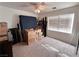 Spacious bedroom with plush carpet, a ceiling fan and window coverings allowing soft natural light at 2549 Sundew Ave, Henderson, NV 89052