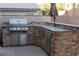 Beautiful outdoor kitchen with granite countertops and stainless steel appliances at 2549 Sundew Ave, Henderson, NV 89052