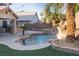 Gorgeous backyard pool with a built-in BBQ, a water slide, and beautiful landscaping at 2549 Sundew Ave, Henderson, NV 89052