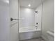 White tiled shower with recessed lighting, bathtub, and chrome shower head fixture at 3056 Garnet Ct, Las Vegas, NV 89121