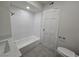 This renovated bathroom includes a shower-tub, vanity, and new tile at 3056 Garnet Ct, Las Vegas, NV 89121