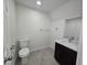 This bathroom features a granite vanity, toilet, and neutral-colored tile at 3056 Garnet Ct, Las Vegas, NV 89121