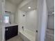 This bathroom includes a tub, shower, vanity, and a dark-stained cabinet at 3056 Garnet Ct, Las Vegas, NV 89121