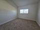 Bedroom with neutral walls, carpet flooring and a large window at 3056 Garnet Ct, Las Vegas, NV 89121