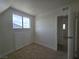 This room boasts a window with natural light, neutral carpet, and white storage cabinets at 3056 Garnet Ct, Las Vegas, NV 89121