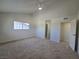 A well-lit bedroom features neutral walls, carpet, and an open doorway to an adjacent room at 3056 Garnet Ct, Las Vegas, NV 89121