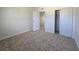 This bedroom features neutral carpeting, a closet, and an open doorway leading to another room at 3056 Garnet Ct, Las Vegas, NV 89121