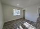 Bright bedroom featuring wood-look floors, a window, and a closet at 3056 Garnet Ct, Las Vegas, NV 89121
