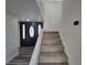 Front entry and staircase of the home with carpeted stairs and wood-look flooring at 3056 Garnet Ct, Las Vegas, NV 89121