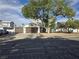 Charming two-story home featuring a three-car garage, mature tree, and low-maintenance landscaping at 3056 Garnet Ct, Las Vegas, NV 89121