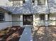 Close-up of a two-story home's entry with a decorative door, pillars, and manicured landscaping at 3056 Garnet Ct, Las Vegas, NV 89121