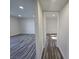 Hallway showcasing modern laminate flooring, fresh paint, and access to multiple rooms at 3056 Garnet Ct, Las Vegas, NV 89121