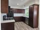 Updated kitchen with dark wood cabinets, stainless steel appliances, and white backsplash at 3056 Garnet Ct, Las Vegas, NV 89121