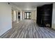 Open living room with wood-look floors, fireplace, and access to a patio at 3056 Garnet Ct, Las Vegas, NV 89121
